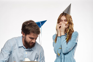 young couple with hats on their heads celebration birthday fun confetti