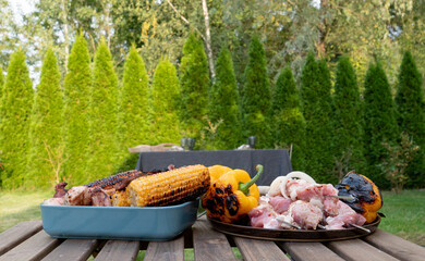 grilled corns and pork meat on a table