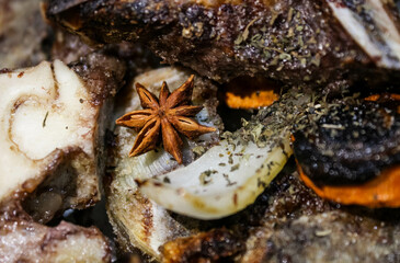 Preparation of beef broth with star anise for Vietnamese pho-bo soup. Spices and meat.