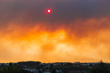 Fire in Manavgat Antalya Turkey, fire fumes and smoke in the city, fire planes and helicopters trying to put out the fire.