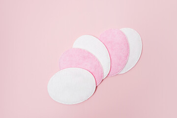 Cosmetic cotton pad on pink background
