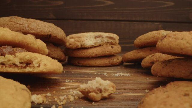 Macro zoom in video of crispy oat cookies on wooden board in kitchen
