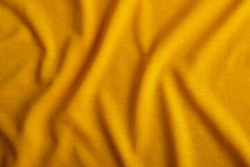 Yellow wrinkle cloth fabric texture surface for background or wallpaper.