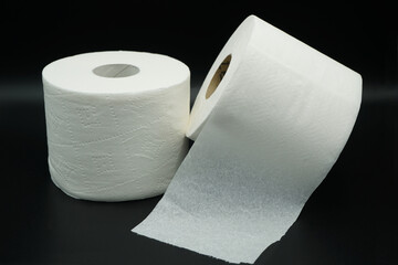 two rolls of white toilet paper isolated onblack background
