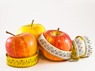 Apples with tape measure - illustrating healthy way to a weight loss