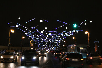 Traffic on the Palace Bridge with colorful New Year's illumination, the evening before Christmas.