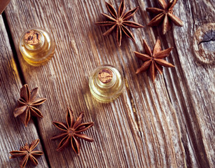 A bottle of aromatherapy essential oil with dried star anise