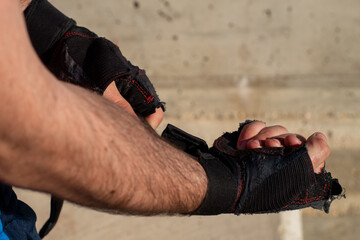 close up of a boy putting on gloves to train outdoors