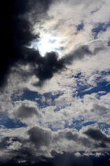 Beautiful dramatic sky with sun rays. Dark clouds and breaking through the sun's rays,. Vertical format