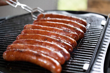 The sausage sits on the grill and gets grilled and the fat drips down the crust.