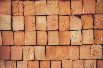 Closeup of stacked red clay handmade bricks