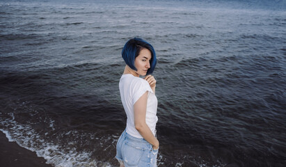 Active healthy young woman enjoying a sandy baltic beach.