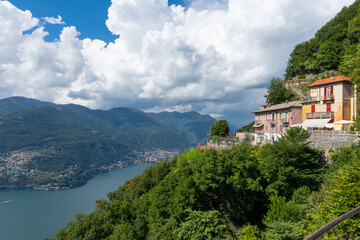 Fototapeta na wymiar Beautiful view over Lake Como and the city of Tavernola, Lombardy, Italy. The view is seen from the small village of Brunate, above the city of Como. It is a sunny, summer day