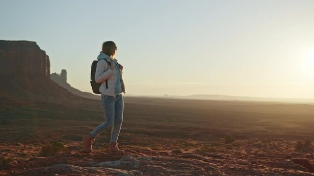 Beautiful model with backpack walking through the natural landscape, Utah USA 4K