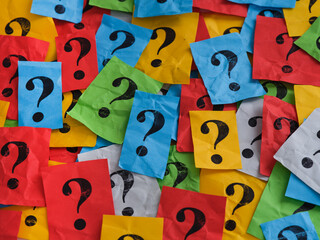 Pile of colorful paper notes with question marks