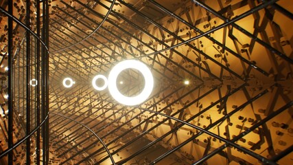 Glowing Light Rings in the Metal Cage Golden Tunnel 3D Render