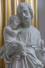 Fototapeta na wymiar Chelm, POLAND - July 5, 2021: Inside the shrine, the Basilica of Virgin Mary in Chelm in eastern Poland. The figure of St. Joseph with Jesus in his arms