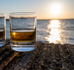 Drinking single malt Scotch whisky at sunset with sea, ocean or river view, private whisky tours in Scotland, UK