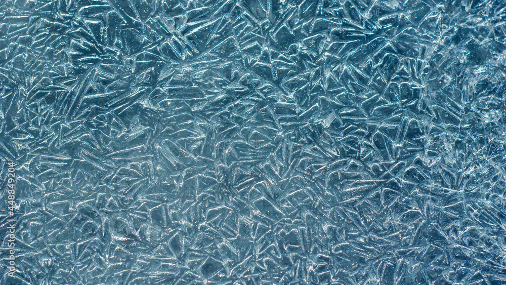 Poster beautiful ice texture with cracks of a frozen puddle on the asphalt for 3d texturing or design.