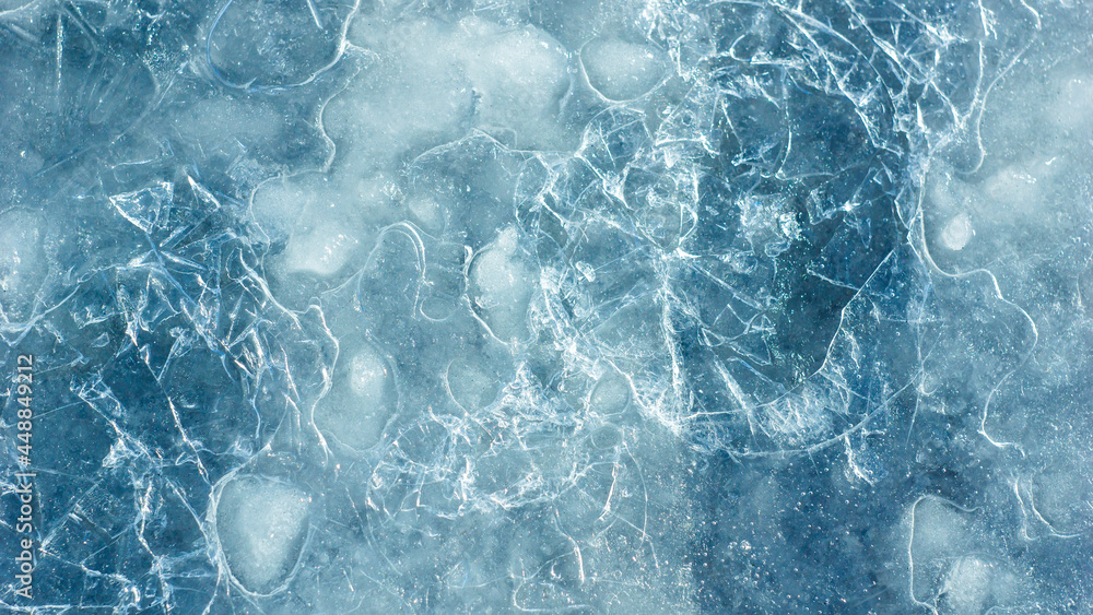 Poster beautiful ice texture with cracks of a frozen puddle on the asphalt for 3d texturing or design.