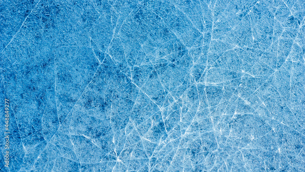 Poster beautiful ice texture with cracks of a frozen puddle on the asphalt for 3d texturing or design.