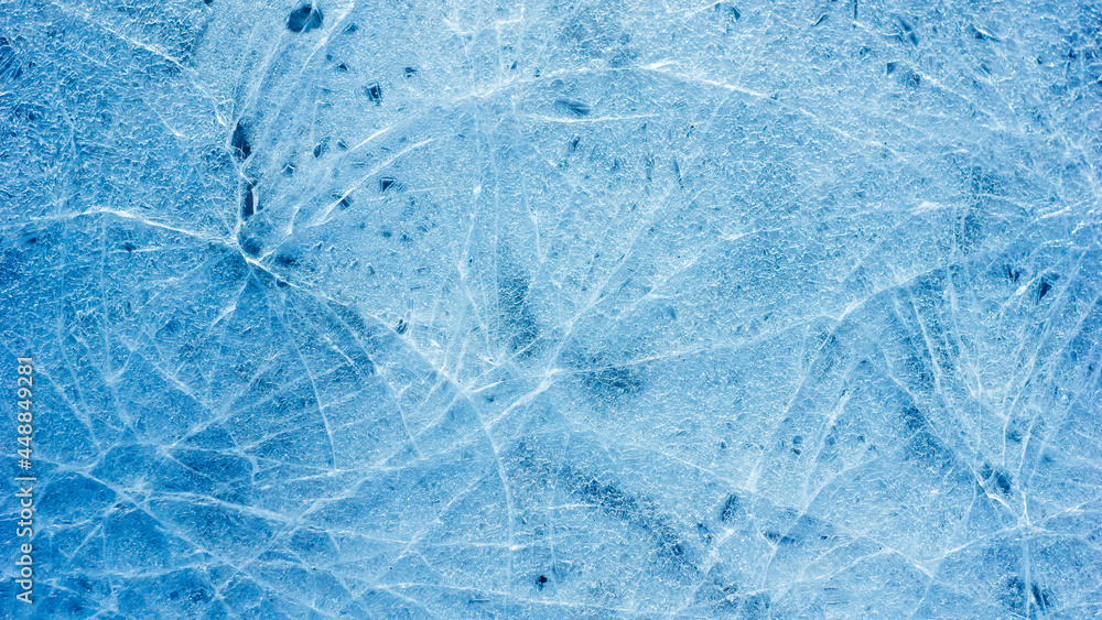 Poster beautiful ice texture with cracks of a frozen puddle on the asphalt for 3d texturing or design.