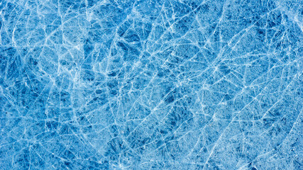 Beautiful ice texture with cracks of a frozen puddle on the asphalt for 3d texturing or design.