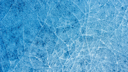 Beautiful ice texture with cracks of a frozen puddle on the asphalt for 3d texturing or design.