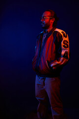 Neon Light hispanic Portrait in trendy jacket and sunglasses