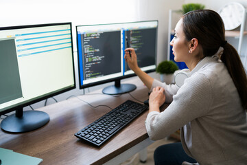 Rear view of a programmer writing code