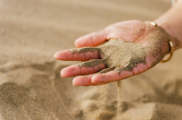 Portrait of young handsome Chinese tourist standing while admiring the sand dunes in Maspalomas