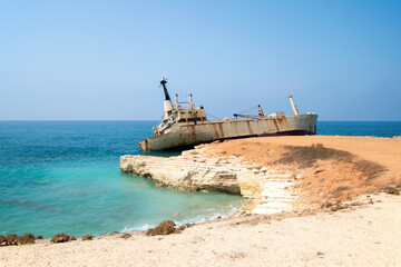 Abandoned ship Edro III near Cyprus beach. Rusty ship ran aground near the shore. High quality photo