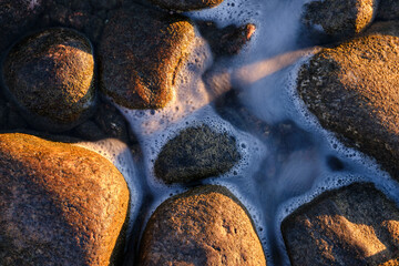 close up of a stone and water