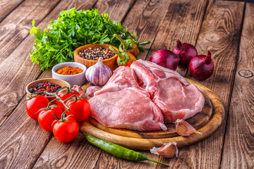 fresh raw new-york steak on wooden Board on wooden background with salt and pepper in a rustic style.