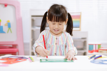 young girl practice drawing different shapes  for homeschooling