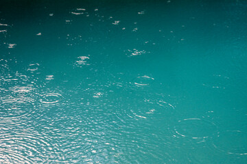 Rain drops in a turquoise pool