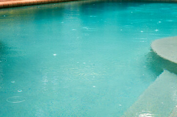 Rain drops in a turquoise pool, step right in