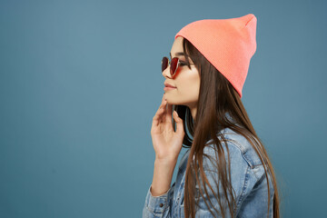 Fototapeta premium pretty woman in denim jacket pink hat glasses fashion modern style