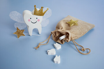 National Tooth Fairy Day. Children tooth fairy. Cute tooth with wings, a crown and a magic wand and...
