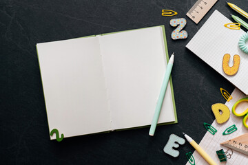 Study, education, learning at school concept on black background with notebook copy space. Working...