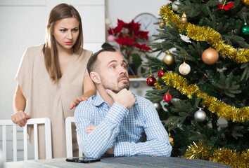 Angry man and woman quarreling during Christmas night