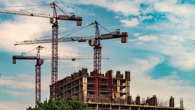 Cranes working day and night on construction of the housing estate in former industrial zone, time lapse