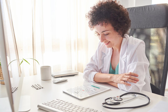 Female doctor consulting the calendar on her tablet