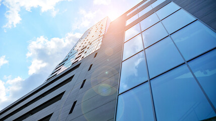 Glass and steel. Mirrored facade of modern office building with sunbeams glare reflection