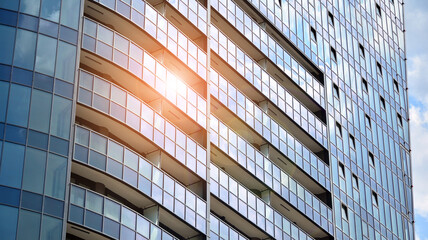Abstract image of the facade of a modern apartment building covered in reflective plates and glass.