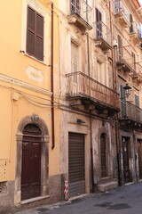Fototapeta na wymiar Antrodoco Street View with Old House Facades and Iron Balconies, Central Italy