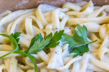 fettuccine noodles with white sauce and green garnish smell.