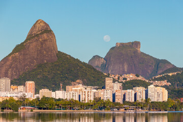 moon setting near Gavea Stone in Rio de Janeiro Brazil.