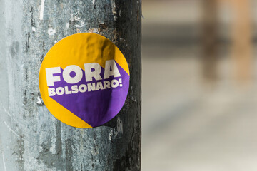 sticker pasted on a post, with the words in brazilian portuguese "Fora Bolsonaro " Bolsoinaro Out