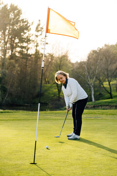 Woman playing golf in park